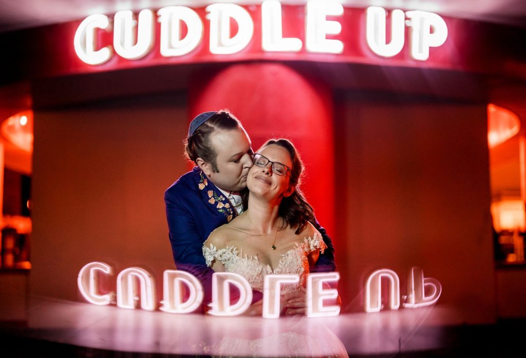 Glen Echo Park Wedding Neon Lights Cuddle Up Couple Portrait