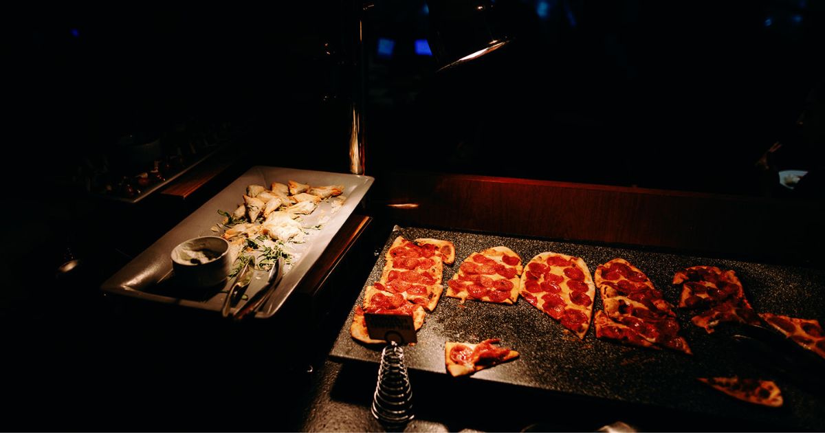 Stationed appetizers and drinks at Pinstripes DC wedding bowling cocktail hour