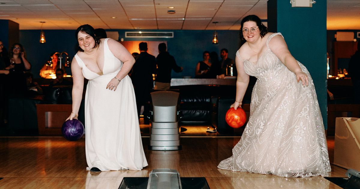 Brides bowling in their wedding attire at Pinstripes DC wedding cocktail hour