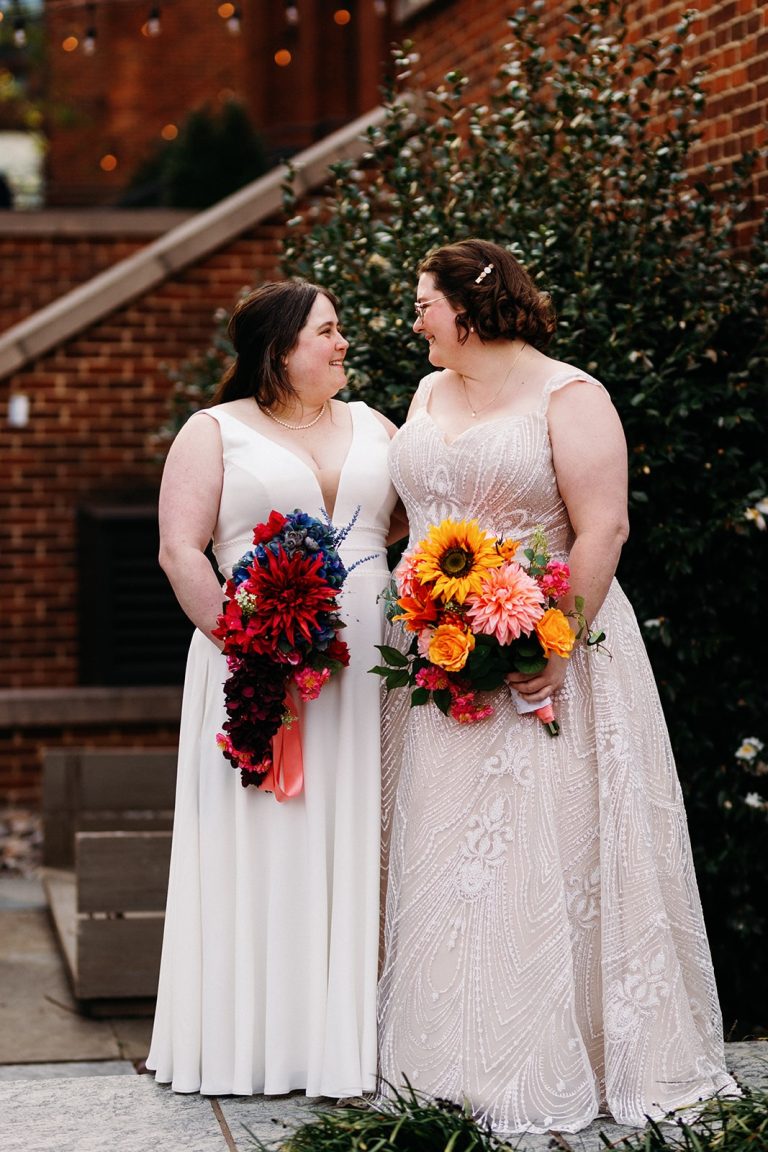 Two brides holding bouquets at the Ritz Carlton Georgetown