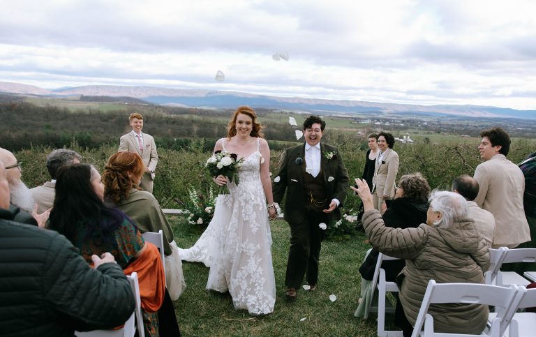 Wedding recessional with newlyweds walking up the aisle