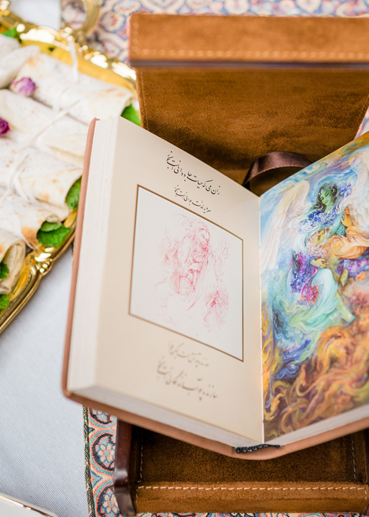 a book with arabic text and colorful watercolor picture of an angel