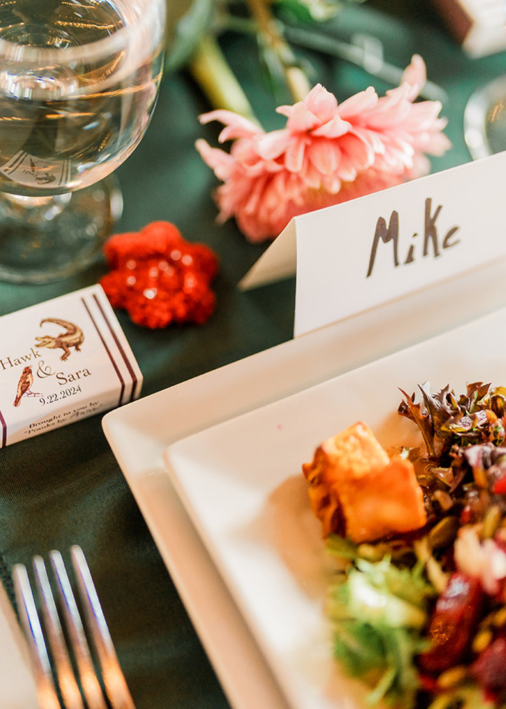 A guest's place card with a small bar of chocolate and a dinner plate