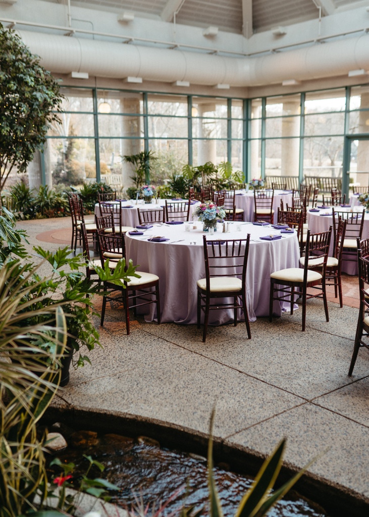 reception tables with light purple linens and floral centerpieces at the atrium at meadowlark gardens
