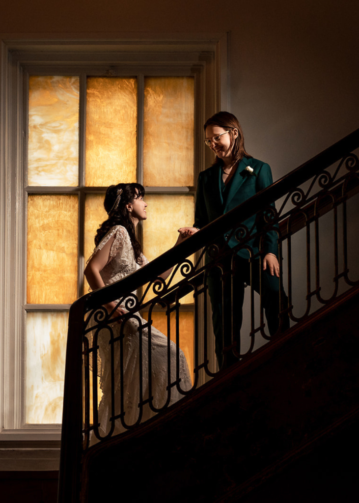 a couple looks at one another on the staircase at the line dc hotel