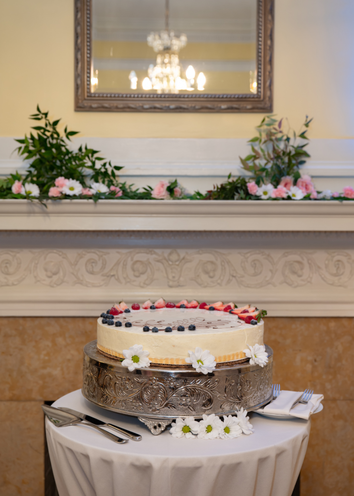 a wedding cake decorated with fruit and flowers