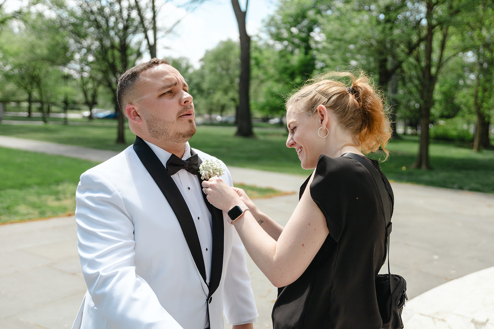 Groom getting boutonniere up by Weddings by Kristy, lead wedding planner and founder, Kristy