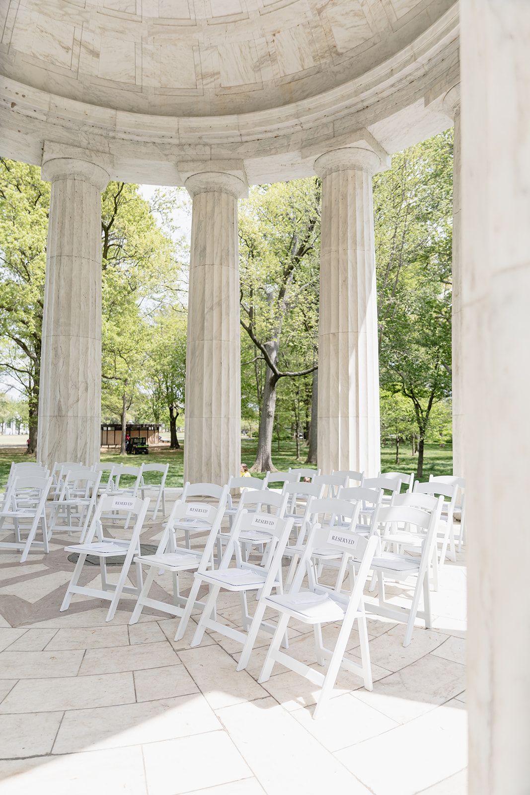 Washington, DC War Memorial wedding ceremony close view of the white chair set up arranged under the marble