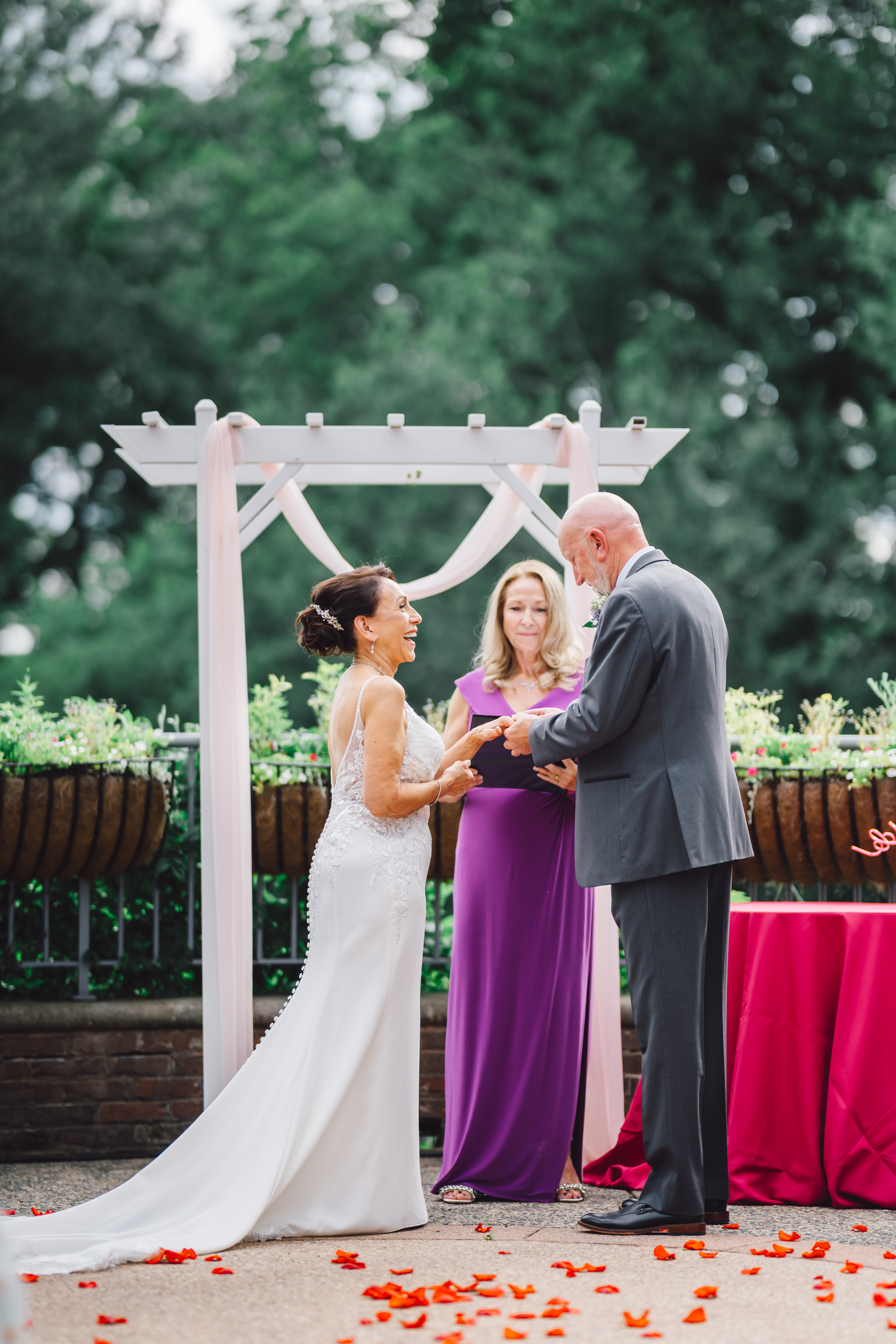 couple at end of aisle holding hands doing vows