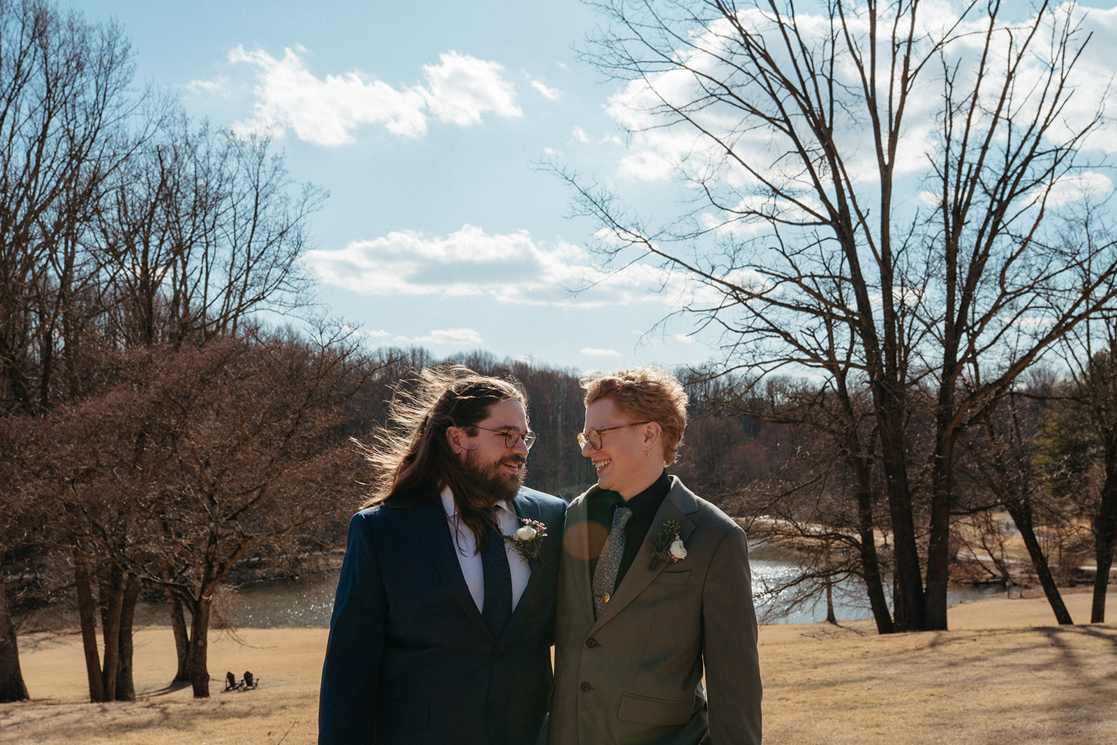 couple looking at one another in the fields of the outdoor venue area