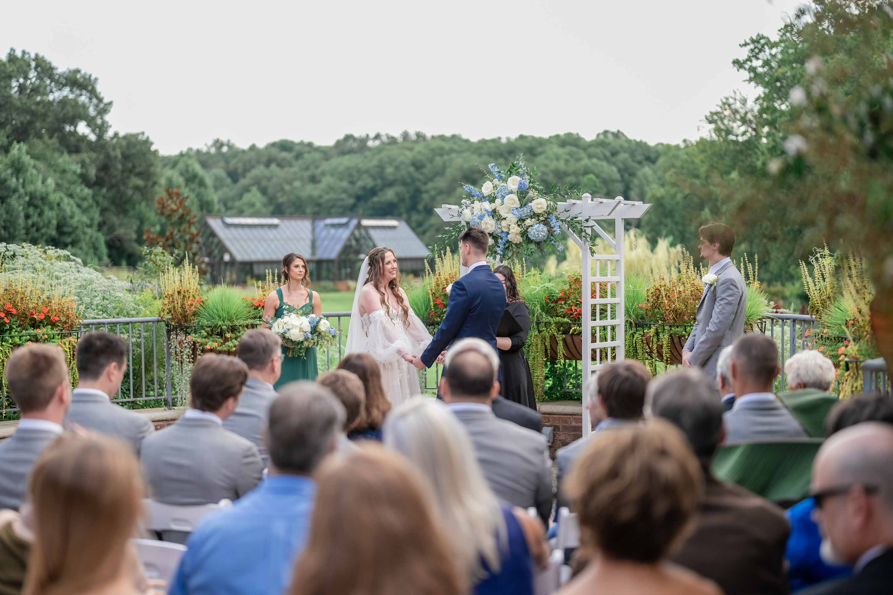couple at ceremony on balcony holding hands