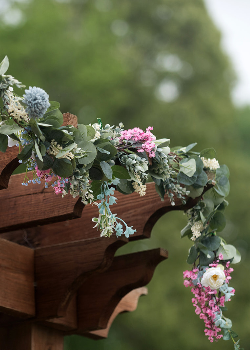 eucalyptus and pink flowers on a pergola outside Running Hare Vineyard