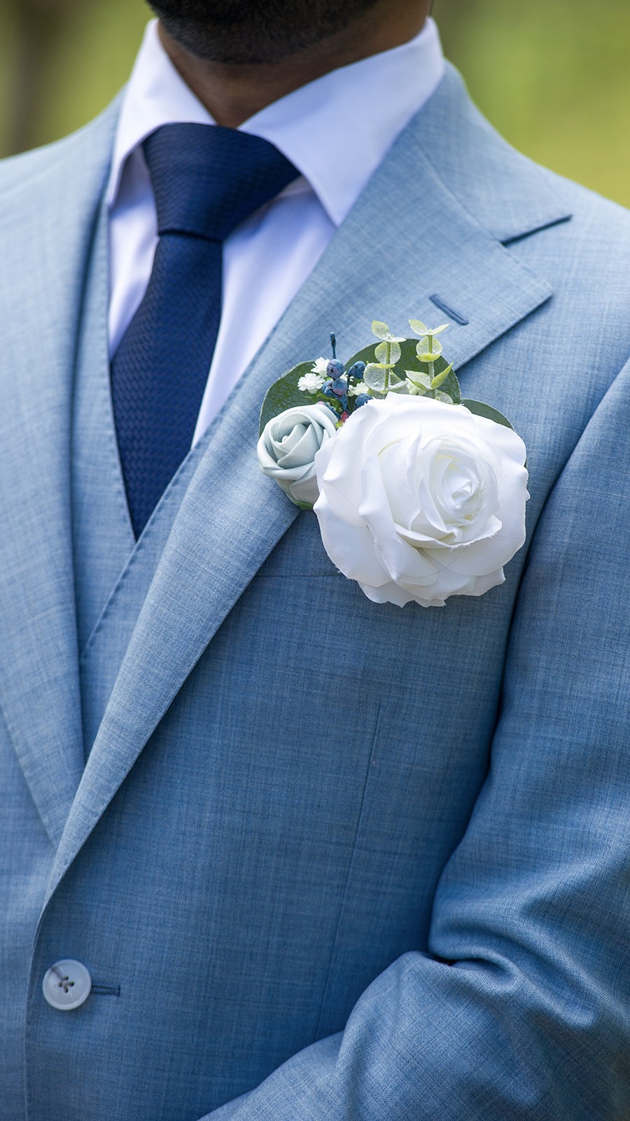 close up of grooms light blue tux and boutonniere