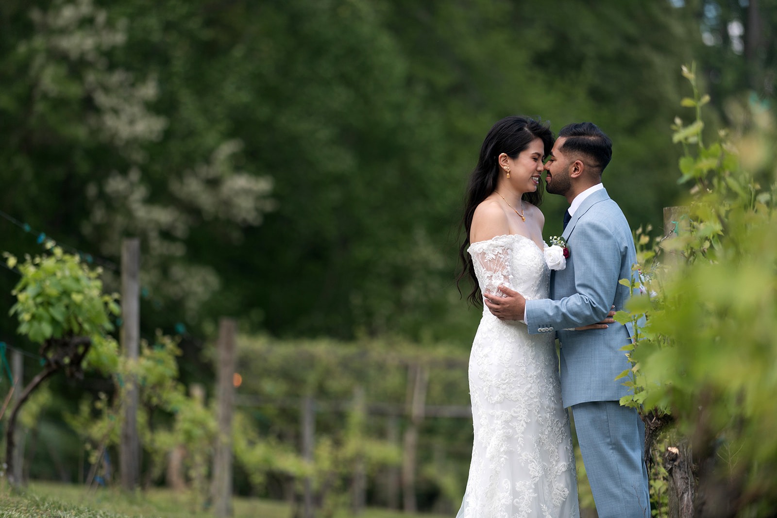 groom and bride in the vineyard holding each other