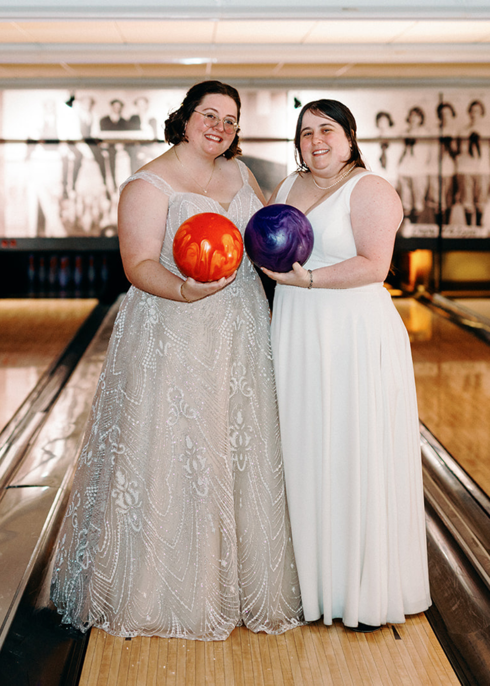 a couple holds two bowling balls while standing on a bowling lane at their Pinstripes Georgetown wedding in Washington DC